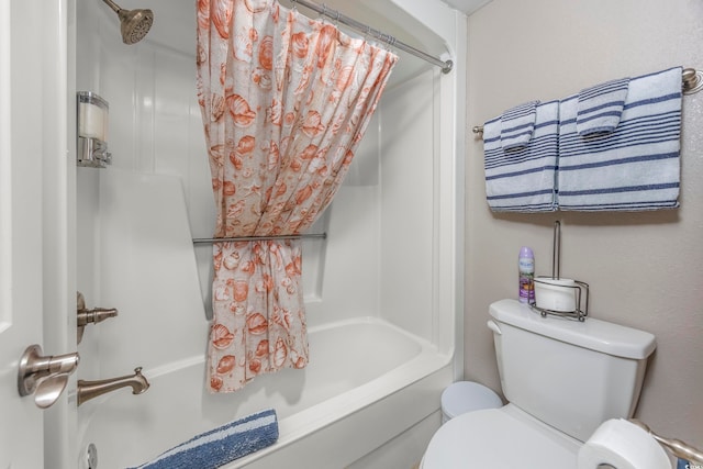 bathroom with shower / bath combo with shower curtain and toilet