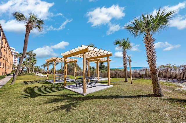 view of home's community featuring a pergola, a water view, and a lawn