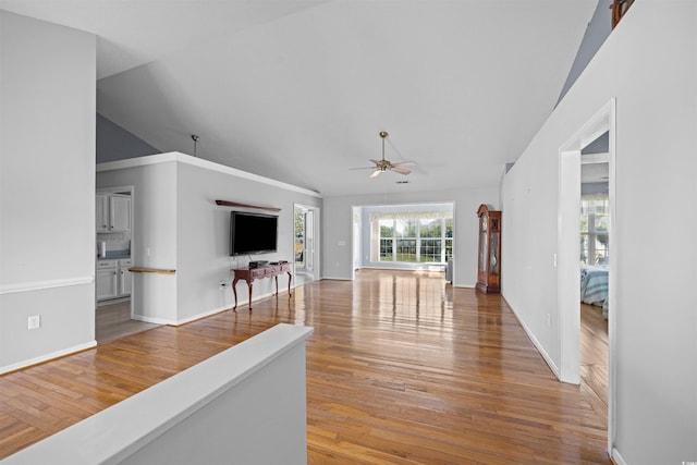 living room with ceiling fan, hardwood / wood-style floors, and high vaulted ceiling