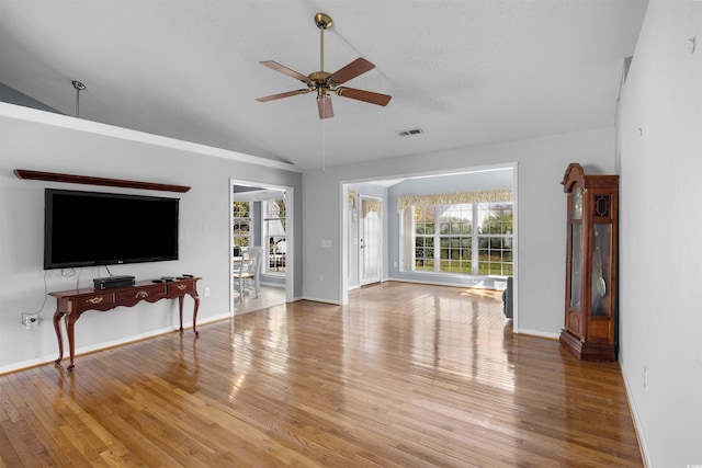 living room with a wealth of natural light, hardwood / wood-style floors, and ceiling fan