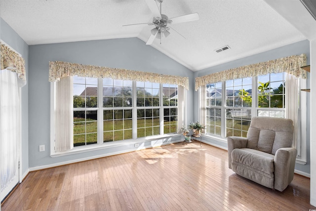 sunroom / solarium featuring ceiling fan and lofted ceiling