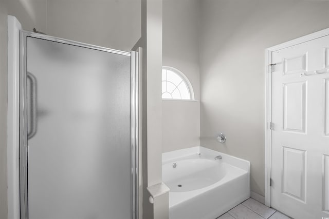 bathroom featuring tile patterned flooring and independent shower and bath