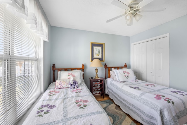 bedroom with a closet, ceiling fan, and hardwood / wood-style flooring