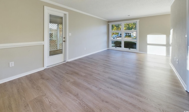 unfurnished living room featuring ornamental molding, a textured ceiling, and light hardwood / wood-style flooring