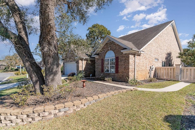 view of front of house featuring a garage and a front lawn