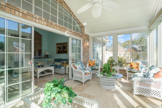 sunroom / solarium with ceiling fan and vaulted ceiling