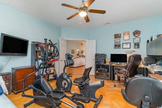 workout room with light parquet floors and ceiling fan