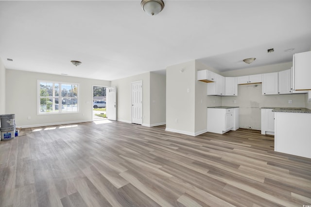 unfurnished living room featuring light hardwood / wood-style floors