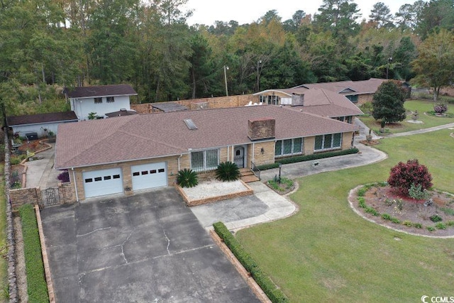 ranch-style house with a front yard and a garage