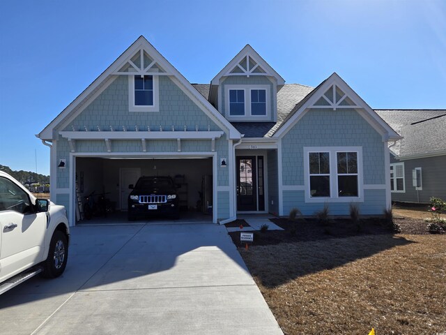 view of front of property featuring a front yard and a garage