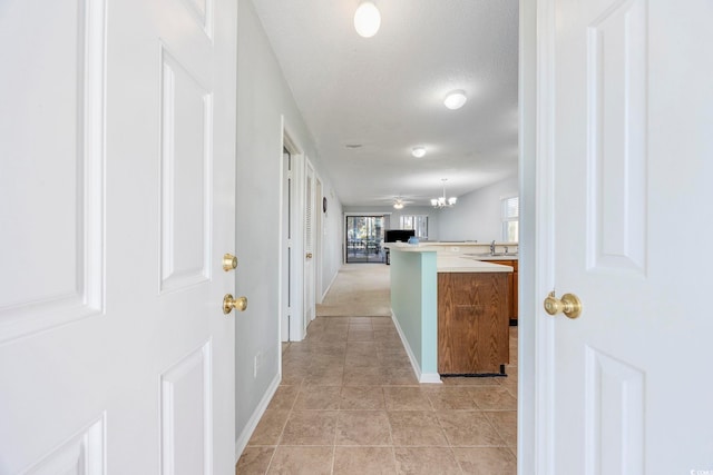 hallway featuring sink and a textured ceiling