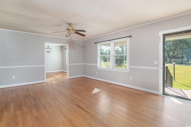 spare room with light wood-type flooring, ceiling fan, and crown molding