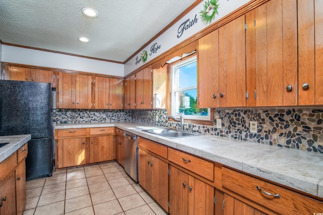 kitchen with dishwasher, sink, black fridge, light tile patterned floors, and ornamental molding