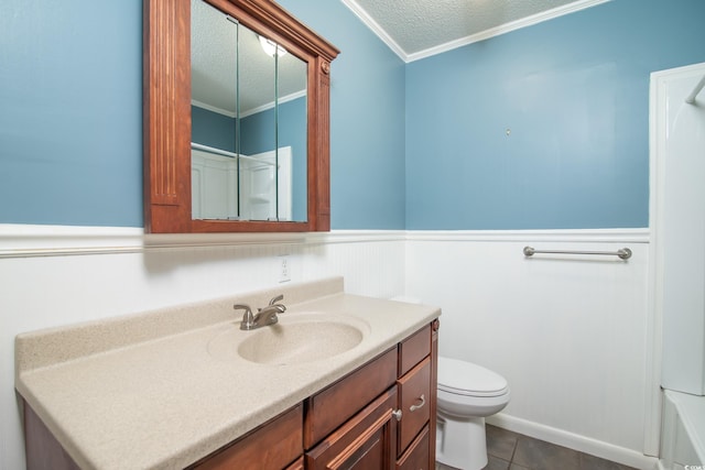 bathroom with tile patterned floors, a shower, toilet, vanity, and ornamental molding