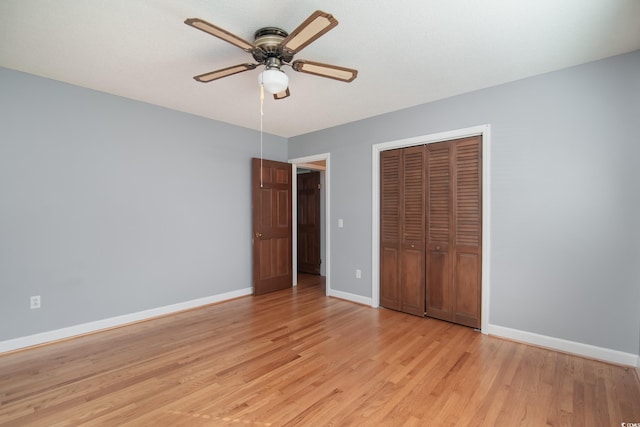 unfurnished bedroom with ceiling fan, light hardwood / wood-style flooring, and a closet