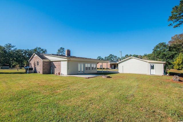 rear view of property with a patio area, a yard, and central AC unit