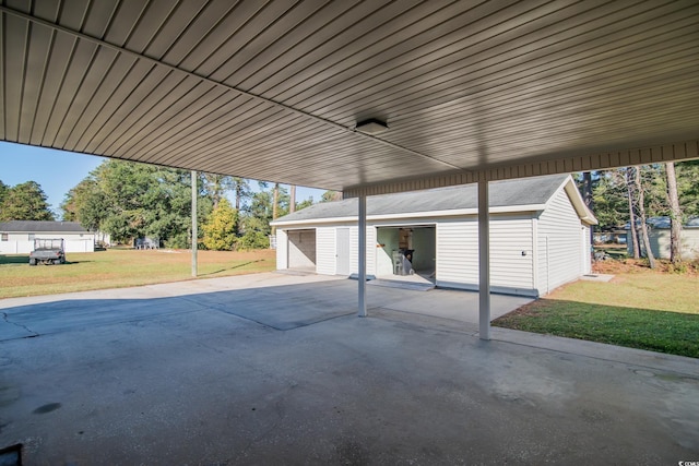 view of patio featuring a carport, a garage, and an outdoor structure