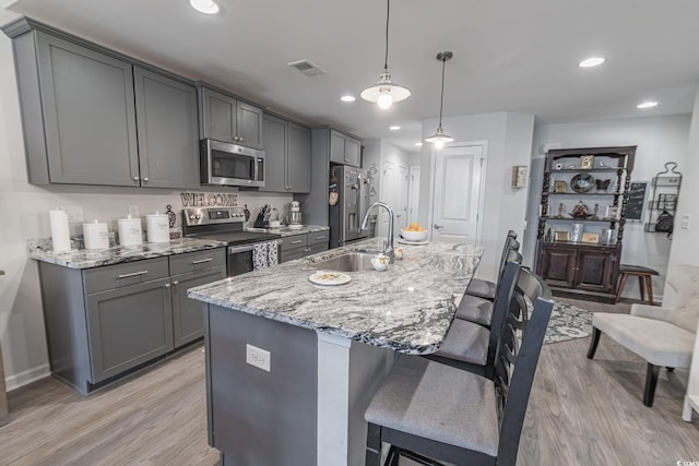 kitchen featuring appliances with stainless steel finishes, gray cabinetry, and sink