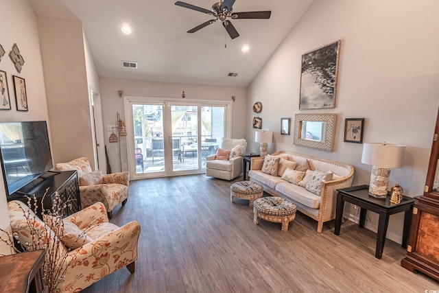 living room featuring hardwood / wood-style flooring, high vaulted ceiling, and ceiling fan