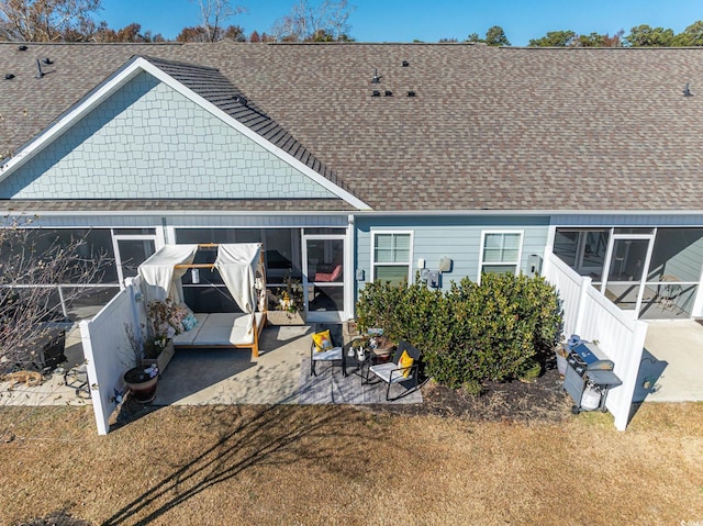 back of house with a lawn and a patio