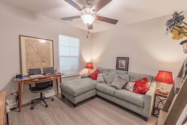 office with light hardwood / wood-style flooring and ceiling fan