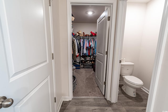 bathroom featuring wood-type flooring and toilet