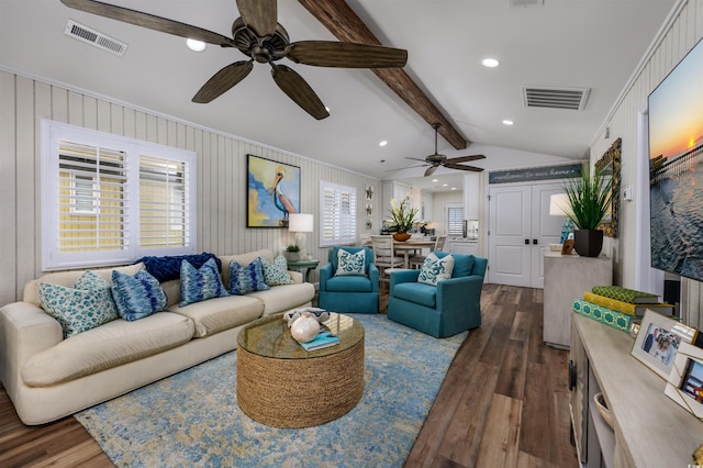 living room featuring dark hardwood / wood-style flooring, lofted ceiling with beams, and crown molding