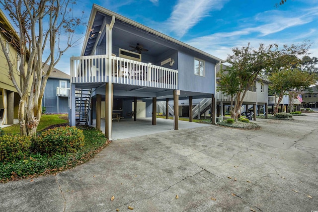 view of front of property with a carport and ceiling fan