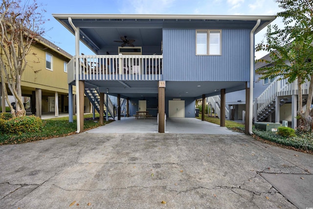 beach home featuring a carport and ceiling fan