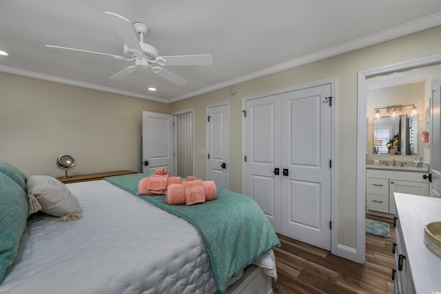 bedroom featuring two closets, ceiling fan, crown molding, connected bathroom, and dark hardwood / wood-style floors