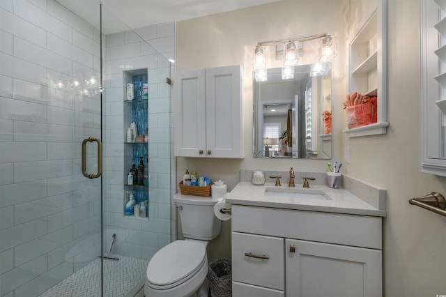 bathroom featuring vanity, toilet, and a shower with shower door