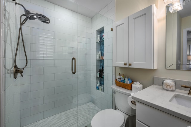 bathroom featuring vanity, toilet, and walk in shower