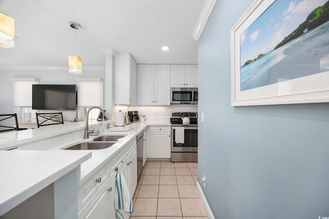 209 N Hillside Dr Unit 201, North Myrtle Beach, SC 29582 - kitchen featuring stainless steel appliances, crown molding, tasteful backsplash, white cabinetry, and light tile patterned floors
