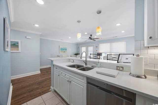 209 N Hillside Dr Unit 201, North Myrtle Beach, SC 29582 - kitchen featuring dishwasher, a ceiling fan, light countertops, ornamental molding, and white cabinets