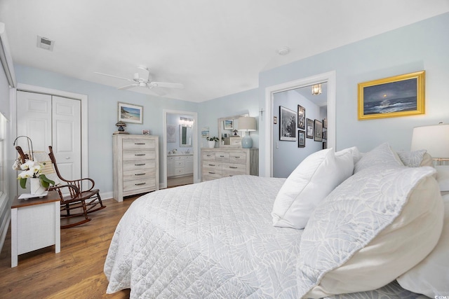 209 N Hillside Dr Unit 201, North Myrtle Beach, SC 29582 - bedroom featuring wood finished floors, ensuite bathroom, and a ceiling fan