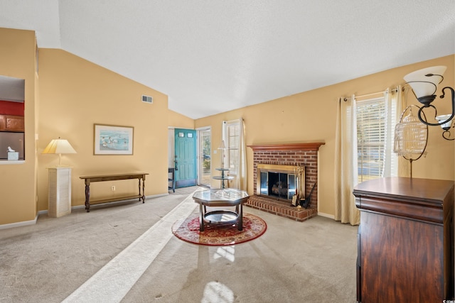 carpeted living room with a textured ceiling, a brick fireplace, and lofted ceiling