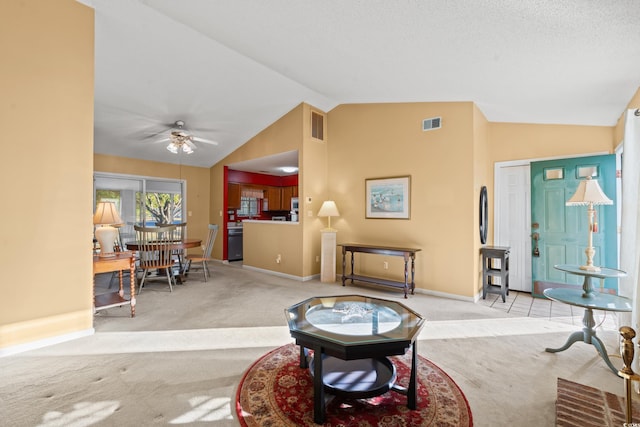 living room featuring a textured ceiling, ceiling fan, light carpet, and vaulted ceiling