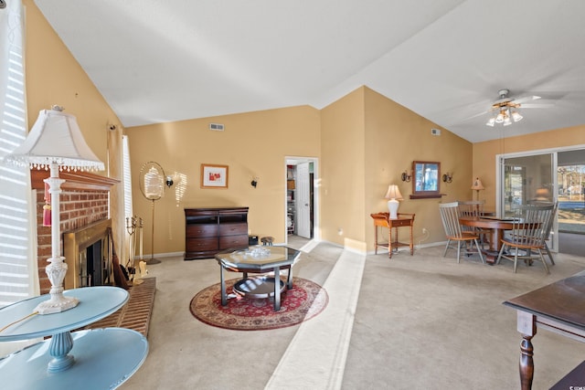 living room with a fireplace, light colored carpet, vaulted ceiling, and ceiling fan