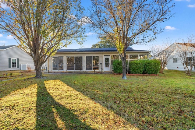 back of house with a yard and central air condition unit