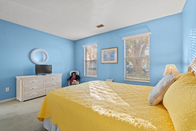 bedroom featuring a textured ceiling and carpet floors