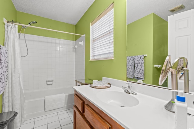 bathroom with tile patterned flooring, vanity, a textured ceiling, and shower / tub combo with curtain