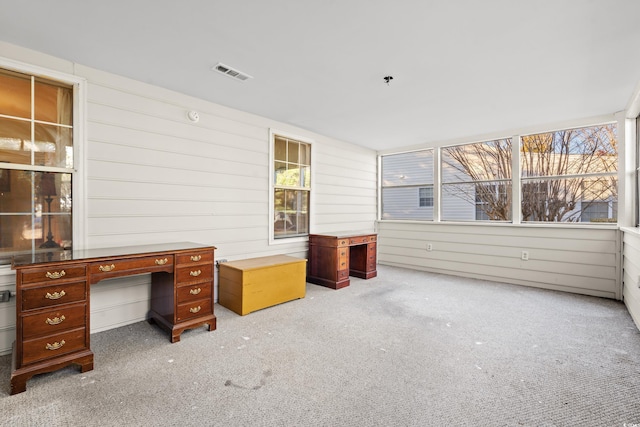 office with carpet flooring and wooden walls