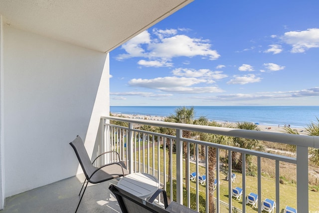 balcony featuring a beach view and a water view