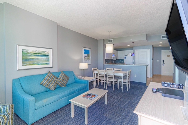 carpeted living room with a textured ceiling