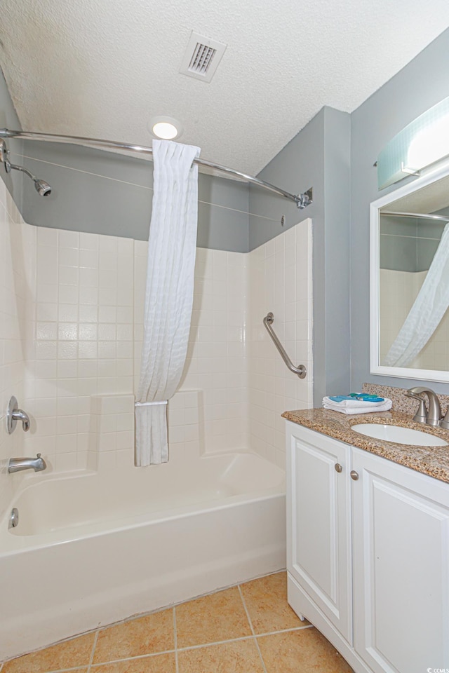 bathroom featuring tile patterned flooring, shower / bath combo, a textured ceiling, and vanity