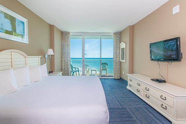 carpeted bedroom featuring access to exterior and floor to ceiling windows