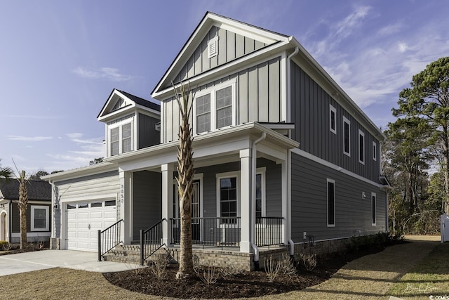 view of front facade with a garage, covered porch, board and batten siding, and driveway