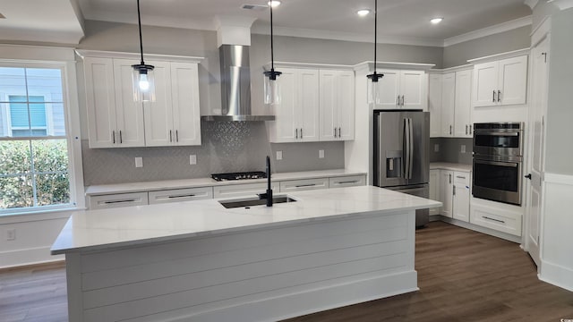 kitchen featuring white cabinetry, a center island with sink, pendant lighting, wall chimney exhaust hood, and light stone counters