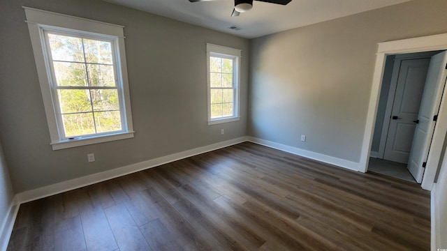 unfurnished room featuring ceiling fan and dark wood-type flooring