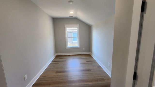 additional living space featuring light hardwood / wood-style flooring and lofted ceiling